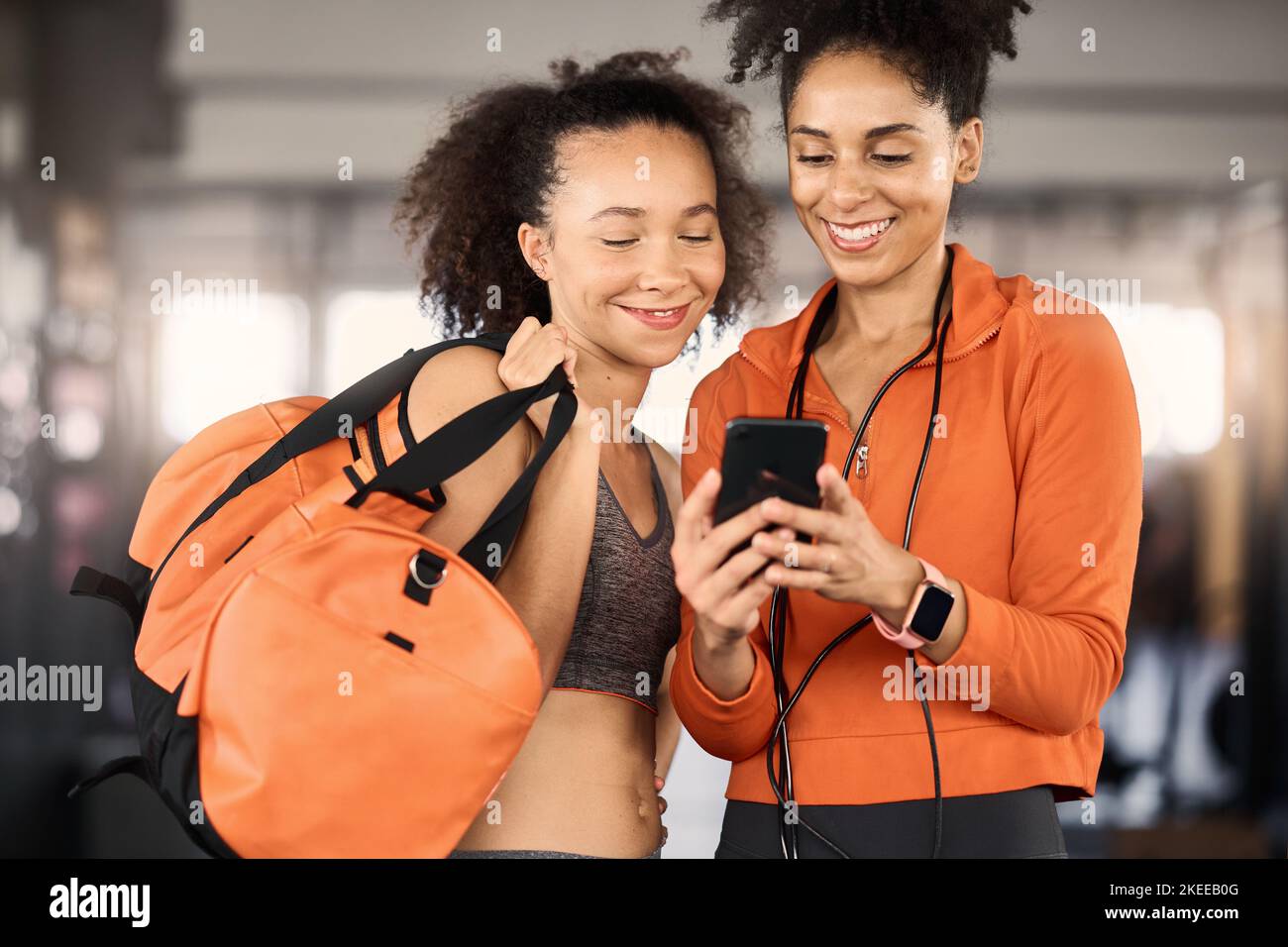 Gym, friends and women with phone, fitness app and planning workout