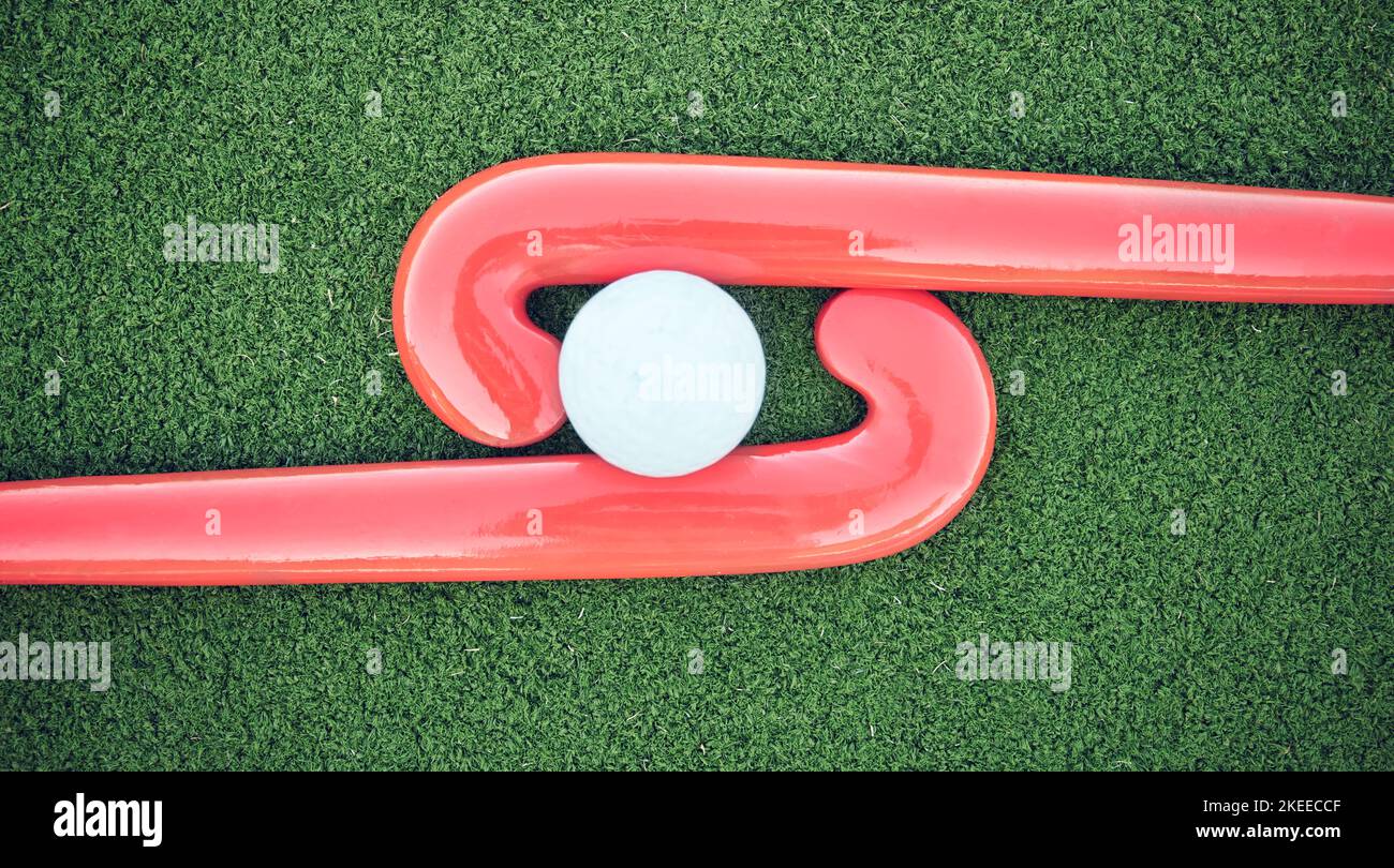 Hockey, ball and stick on green field, pitch and equipment against