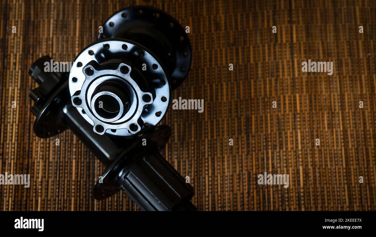 Bicycle front hub and rear hub on wooden background Stock Photo