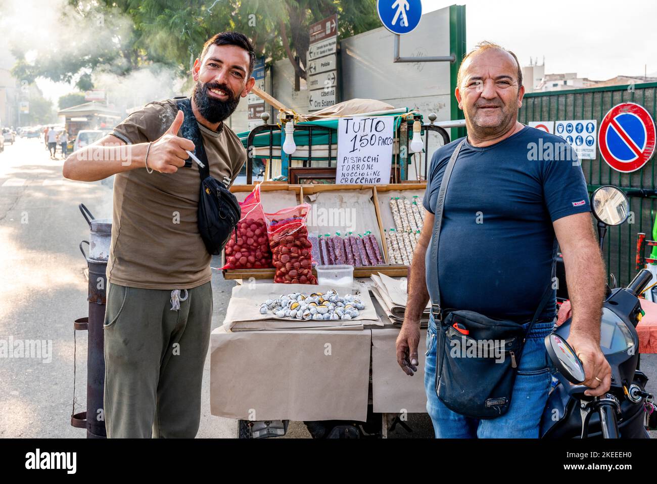 A Man Selling Roast Chestnuts and Other Nuts From A Stall In Palermo, Sicily, Italy. Stock Photo