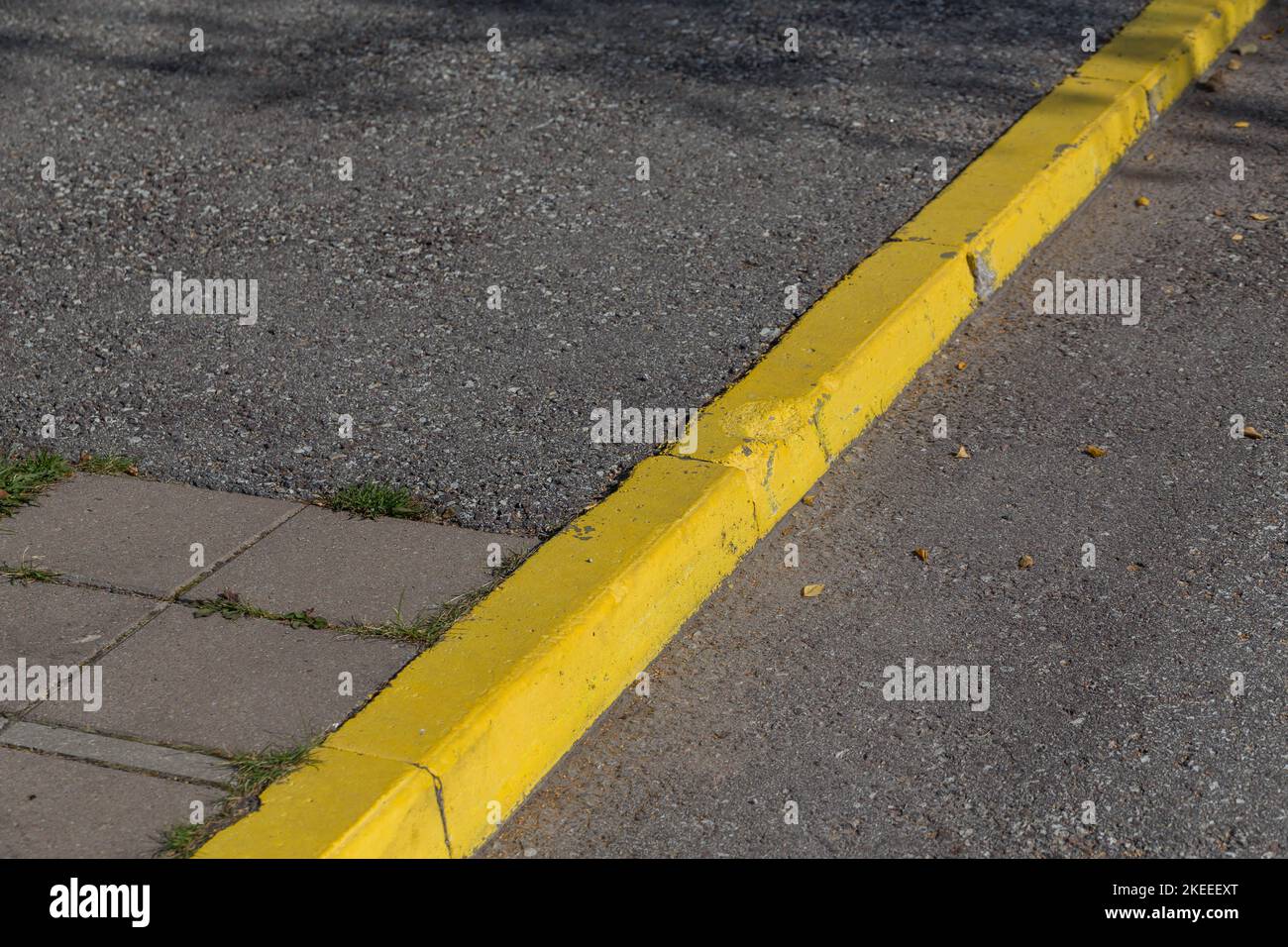 Yellow curb stone border for sidewalk and asphalt road Stock Photo Alamy