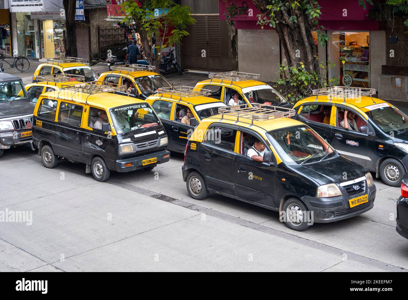 MUMBAI - SEP 20: Rows of traditional Mumbai yellow and black cabs, taxi in a city street on September 20. 2022 in India Stock Photo