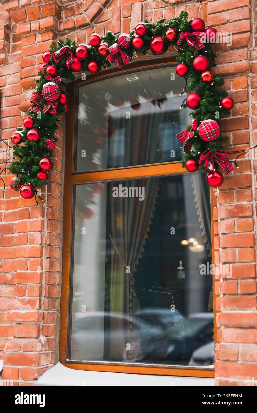 Stylish christmas fir branches with red baubles and sparkling garland ...
