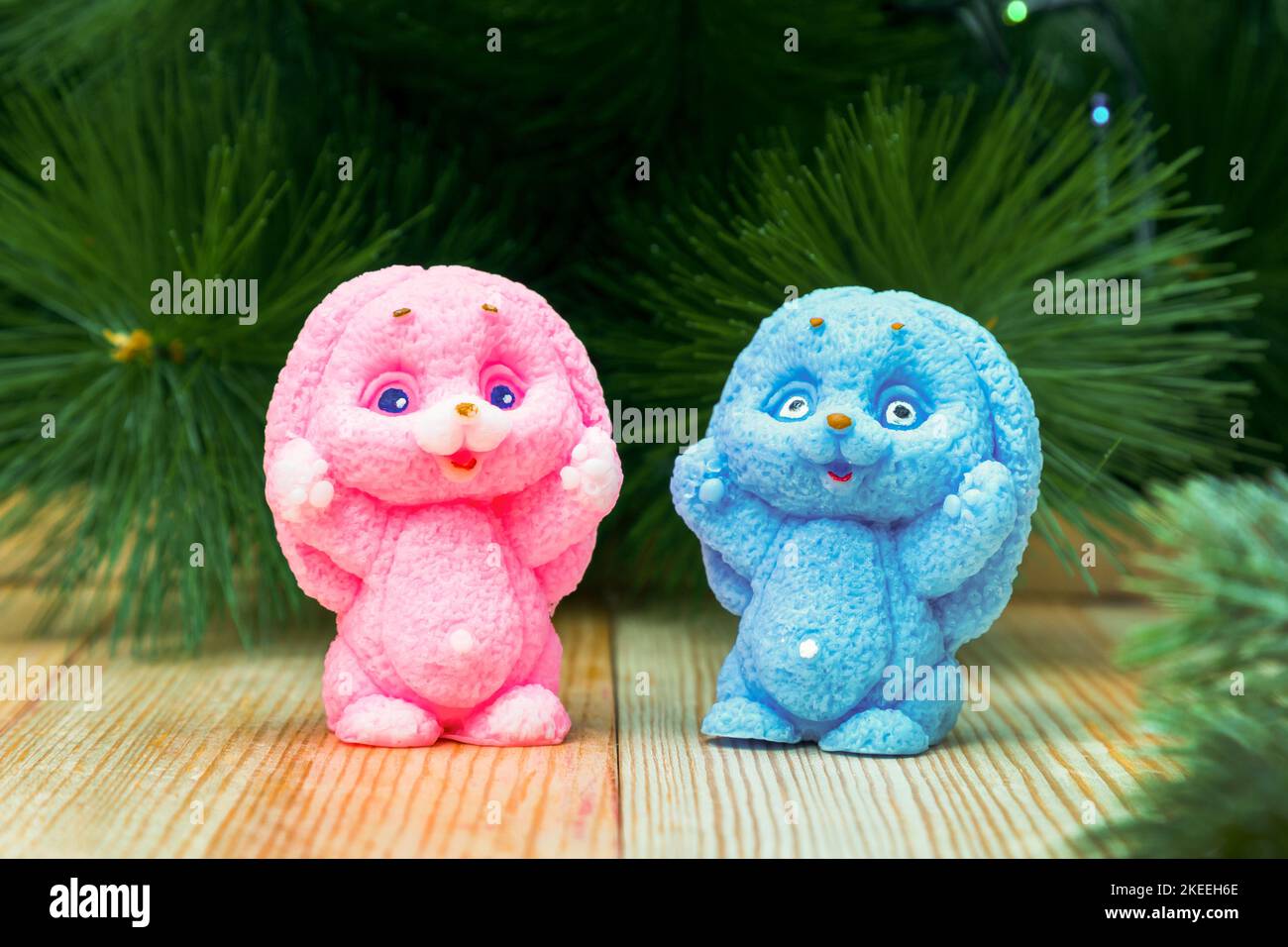 Pink and blue handmade soap bunny at the Christmas tree, symbol of the 2023 New Year Stock Photo