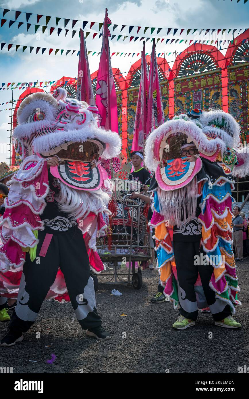 Lion dancers prepare their elaborate, colourful puppets for a performance at the decennial Da Jiu festival, Kam Tin, New Territories, Hong Kong, 2015 Stock Photo