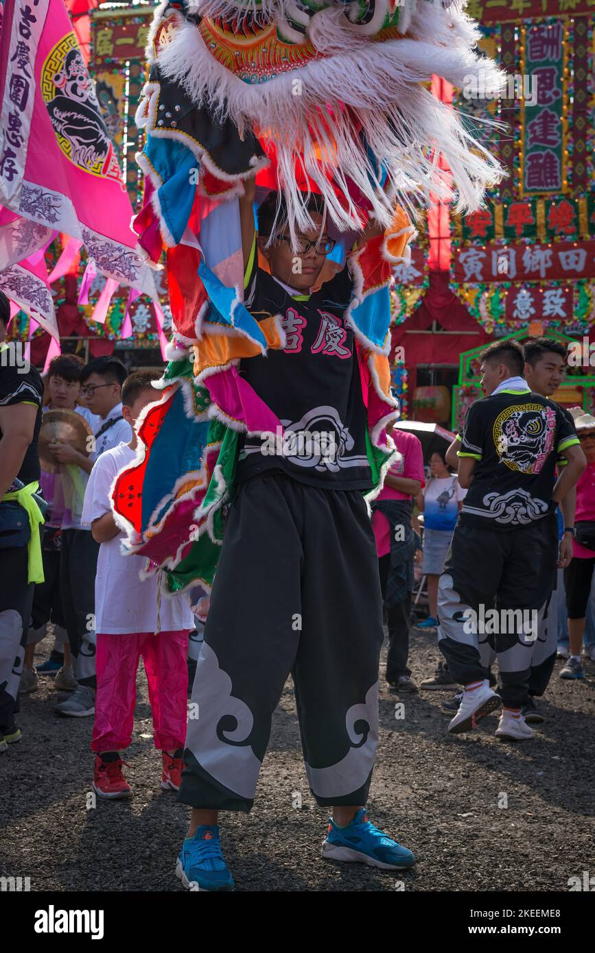 Lion dancers prepare their elaborate, colourful puppets for a performance at the decennial Da Jiu festival, Kam Tin, New Territories, Hong Kong, 2015 Stock Photo