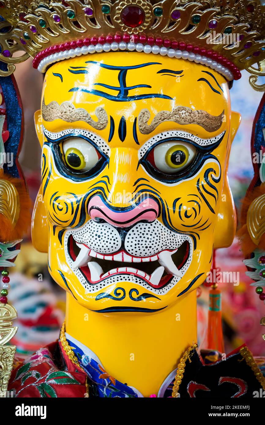 Painted head of a life-size puppet of a demon, used in ritual processions at the decennial Da Jiu festival, Kam Tin, New Territories, Hong Kong, 2015 Stock Photo