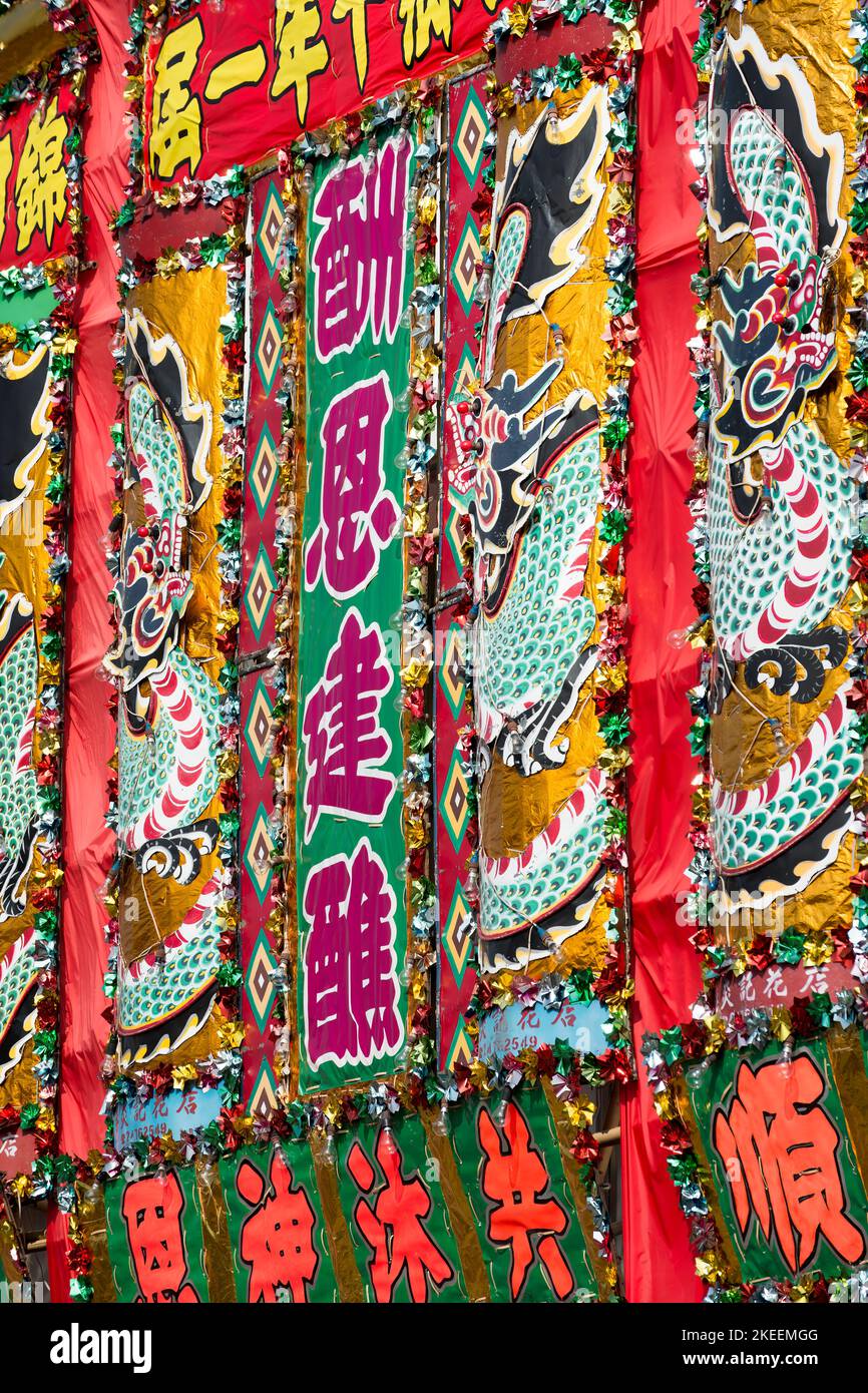 Colourful flower plaques (‘fa paai’) decorate the main street of Kam Tin town for the decennial Da Jiu festival, New Territories, Hong Kong, 2015 Stock Photo
