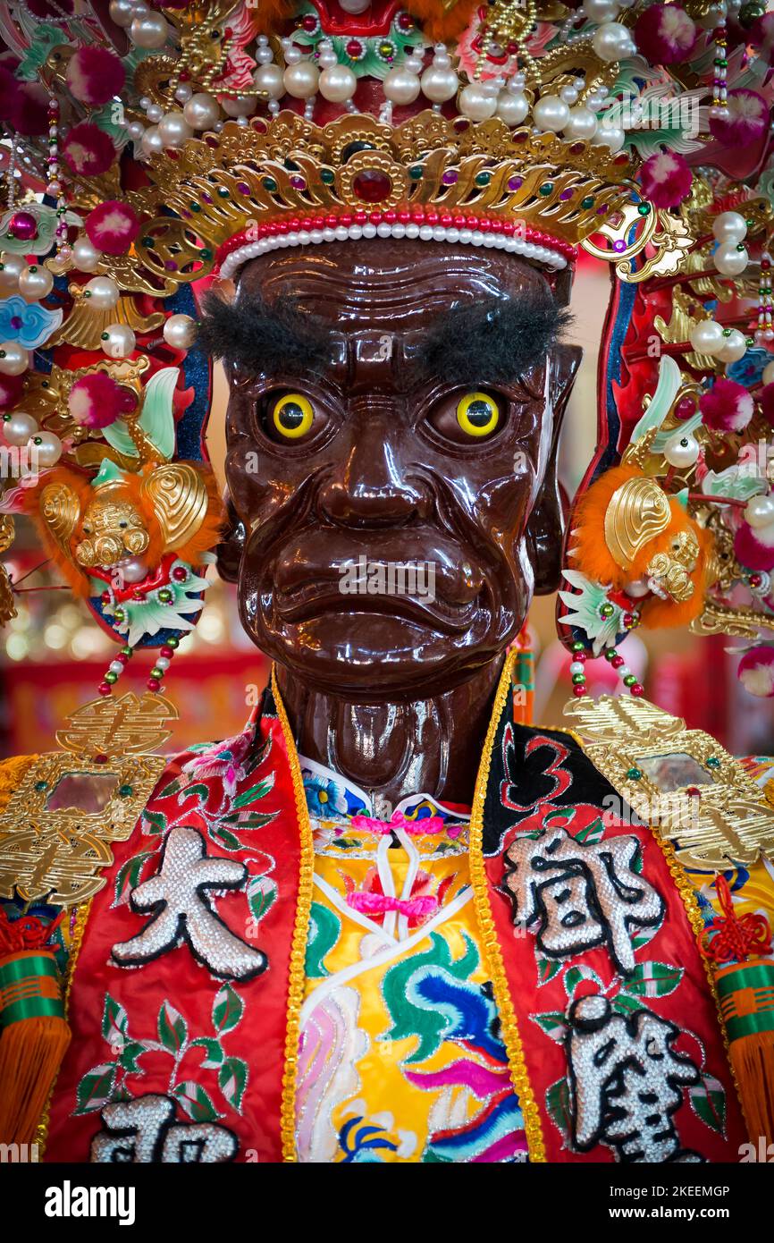 Painted head of a life-size puppet of a demon, used in ritual processions at the decennial Da Jiu festival, Kam Tin, New Territories, Hong Kong, 2015 Stock Photo