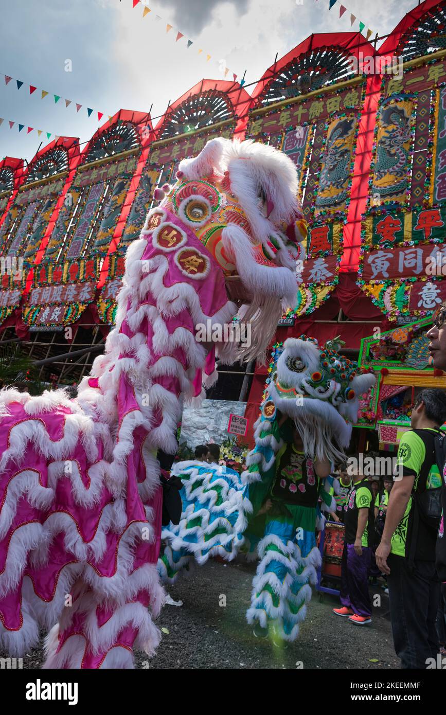 Lion dancers prepare their elaborate puppets for a performance at the decennial Da Jiu festival site, Kam Tin, New Territories, Hong Kong, 2015 Stock Photo