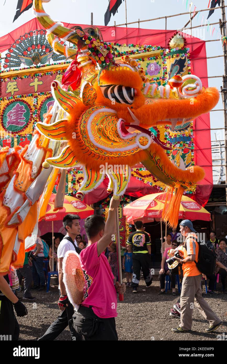 Villagers perform a traditional, colourful dragon dance at the decennial Da Jiu festival site, Kam Tin, New Territories, Hong Kong, 2015 Stock Photo