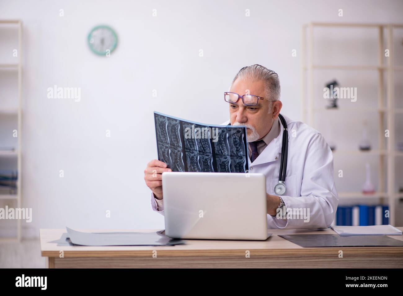 Old male doctor radiologist working in the clinic Stock Photo - Alamy