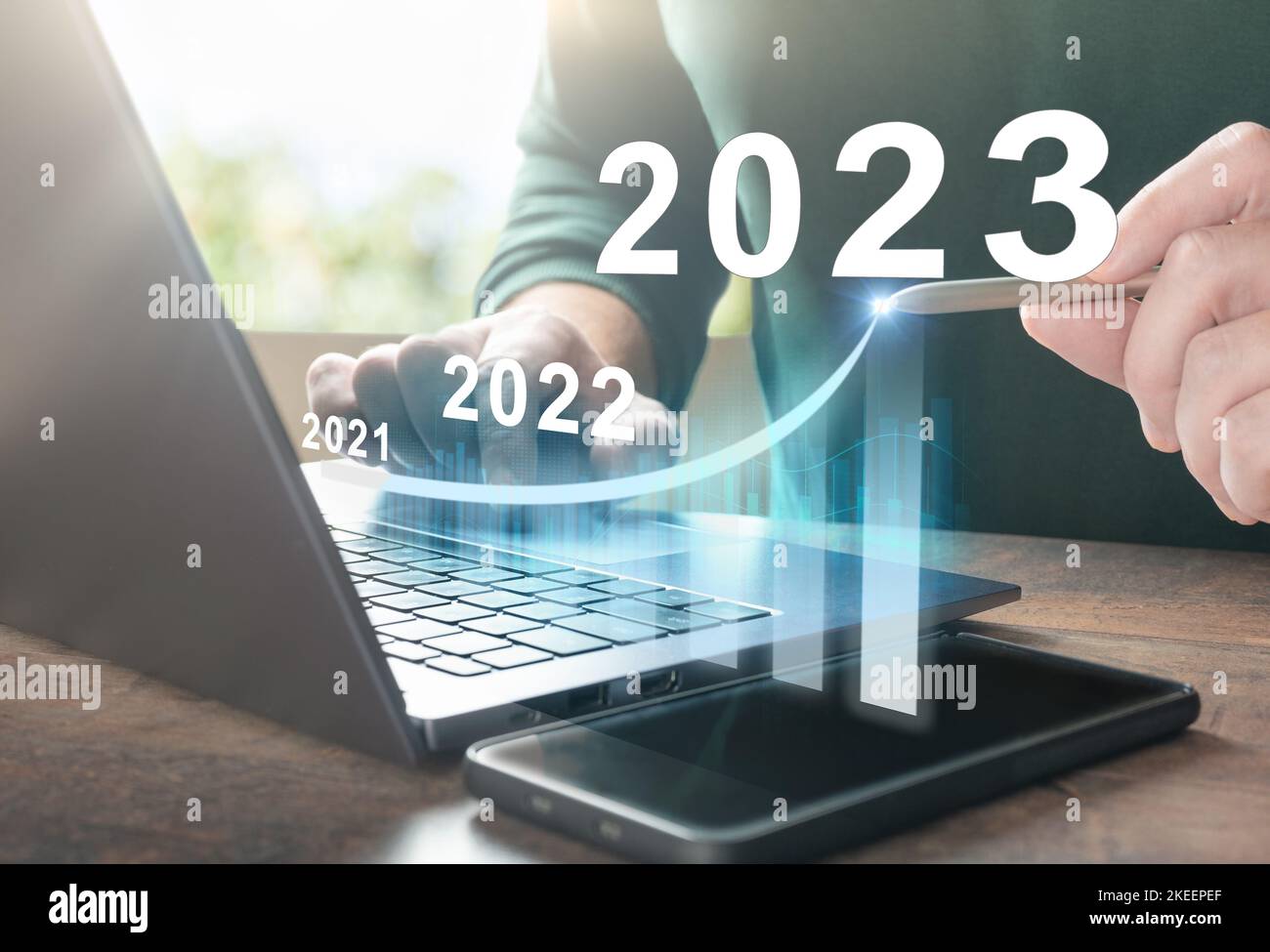 2023 new year. Business person using laptop with hologram growth chart. Business success and investment growth in 2023 years. Business finance technol Stock Photo