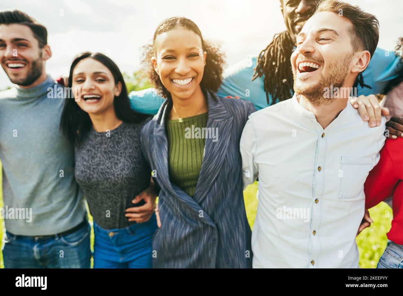 Multiethnic young friends having fun outdoor - Soft focus on right guy ear Stock Photo
