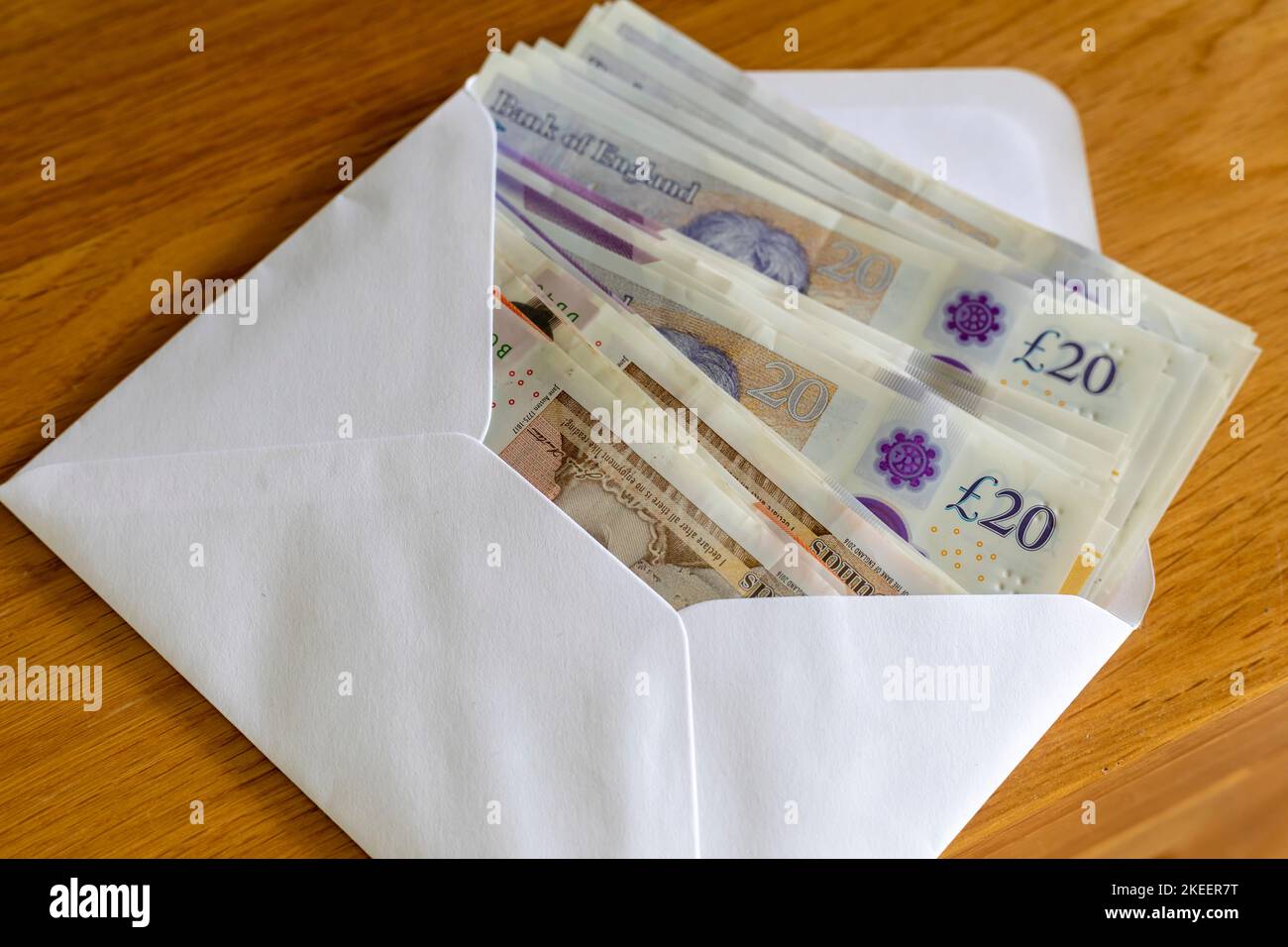 An envelope full of British £20 and £10 pound notes Stock Photo
