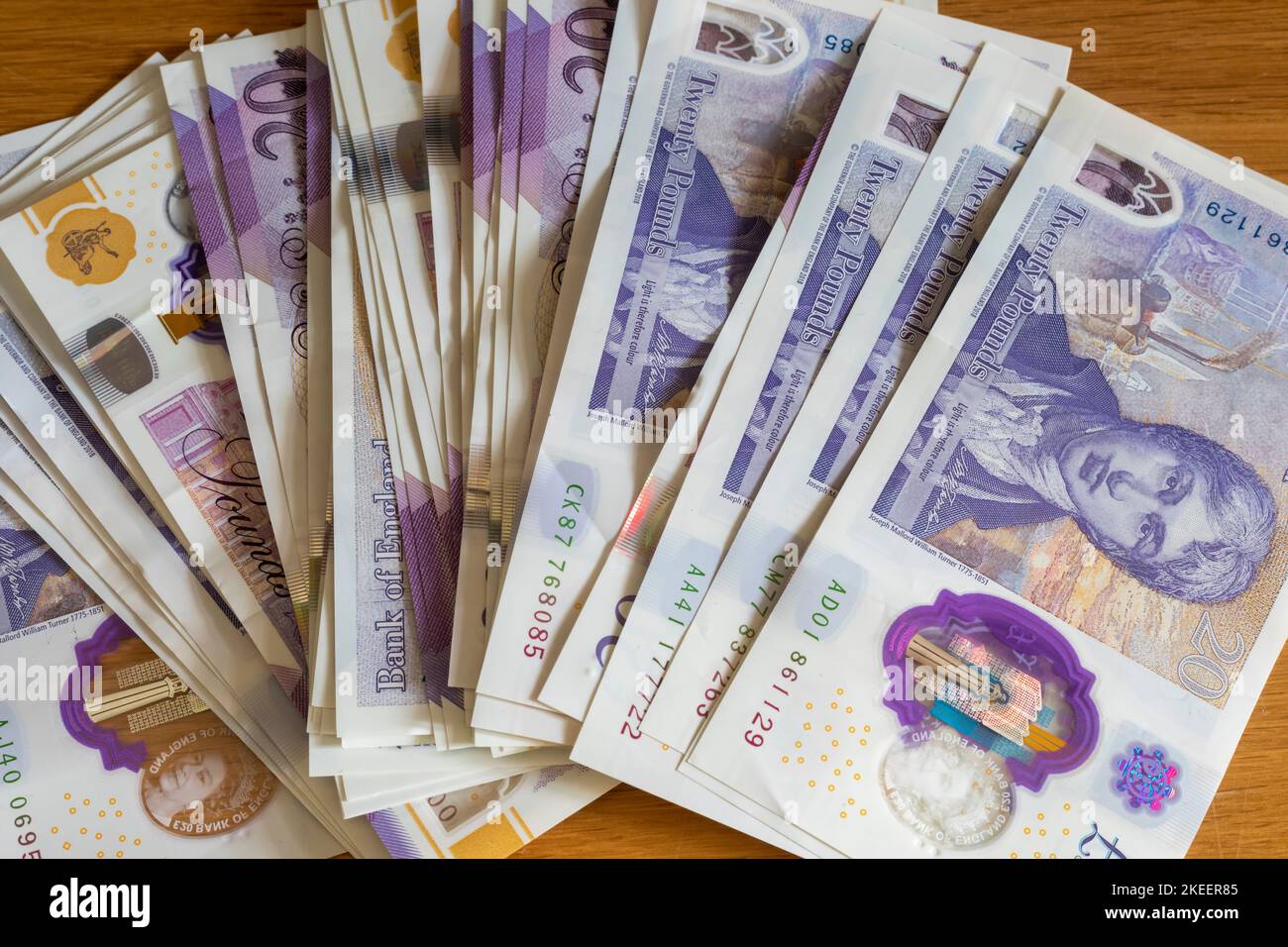 A pile of British £20 and £10 pound notes laid out on a table Stock Photo