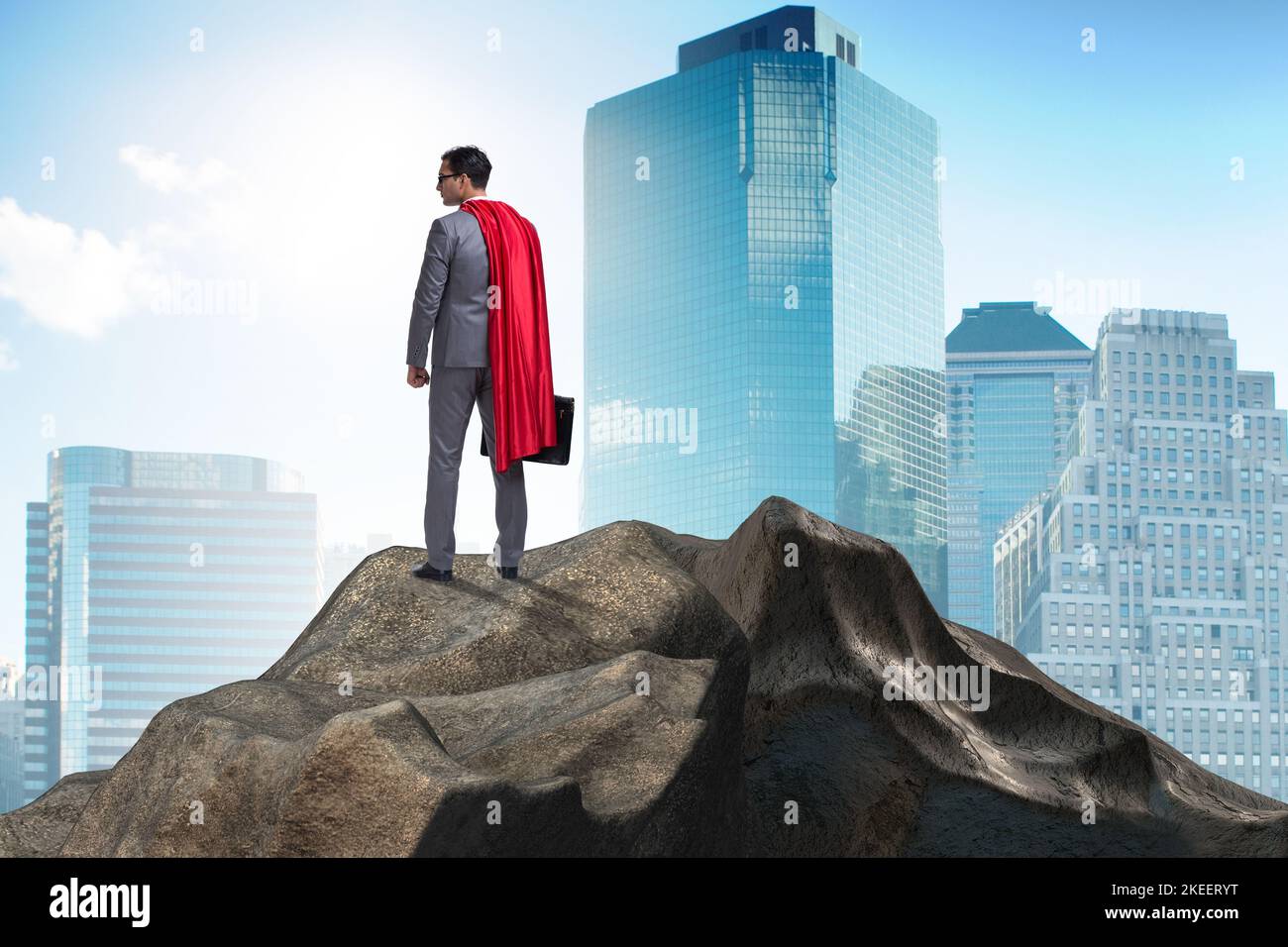 The superhero businessman on top of mountain Stock Photo - Alamy