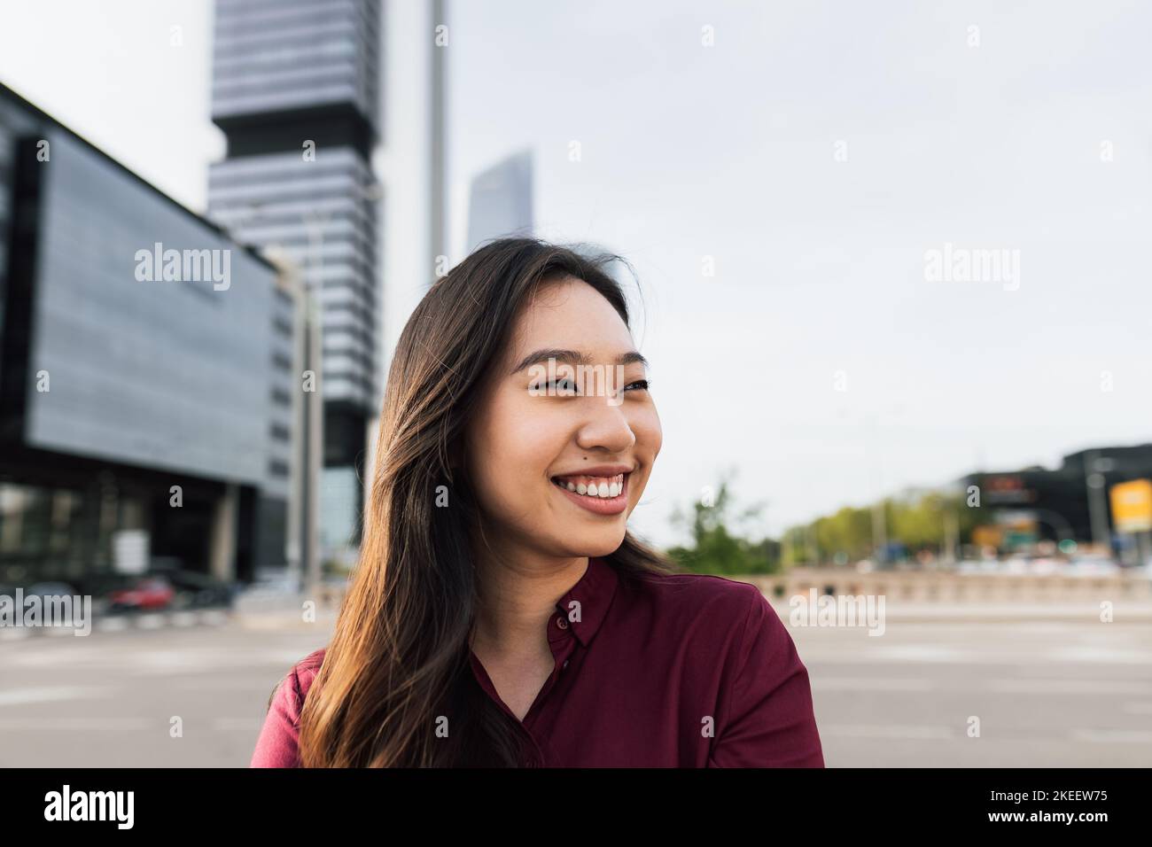 Happy Asian business woman outside enterprise office Stock Photo