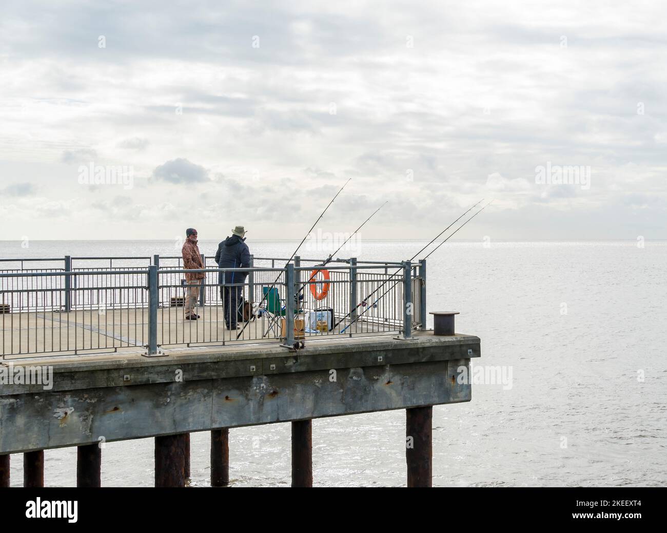 Two fishermen talking at end of Southwold pier suffolk 2022 Stock Photo