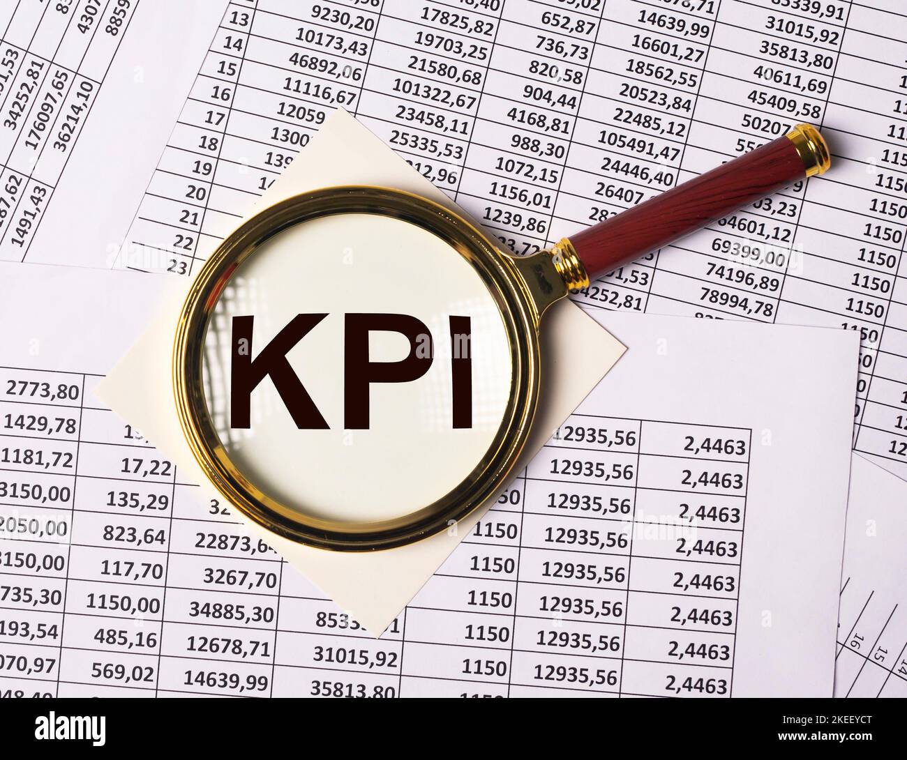 KPI through magnifying lens on documents with numbers Stock Photo - Alamy