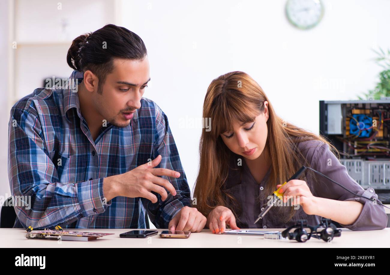 The two technicians working at computer warranty center Stock Photo