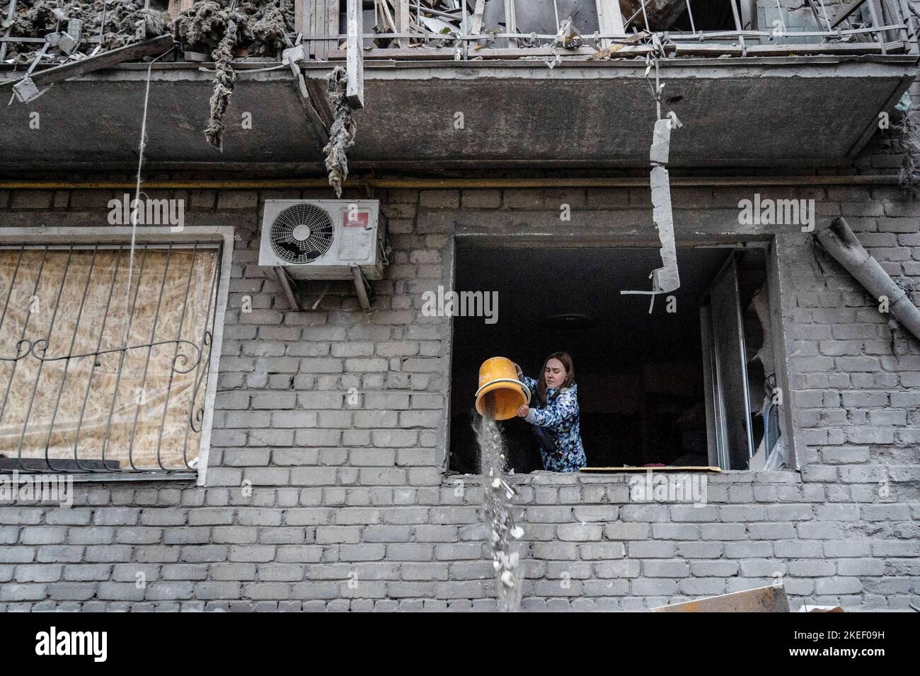 Mykolaiv, Ukraine. 11th Nov, 2022. A resident was seen cleaning the debris in her apartment. A Russian missile attack on a residential building in the Inhulskyi district of Mykolaiv, a southern city in Ukraine. The deadly attack killed at least 7. Mykolaiv is a city 50 km away from Kherson city, where the Ukrainian force has gained a huge battlefield success in the past couple of days. Credit: SOPA Images Limited/Alamy Live News Stock Photo