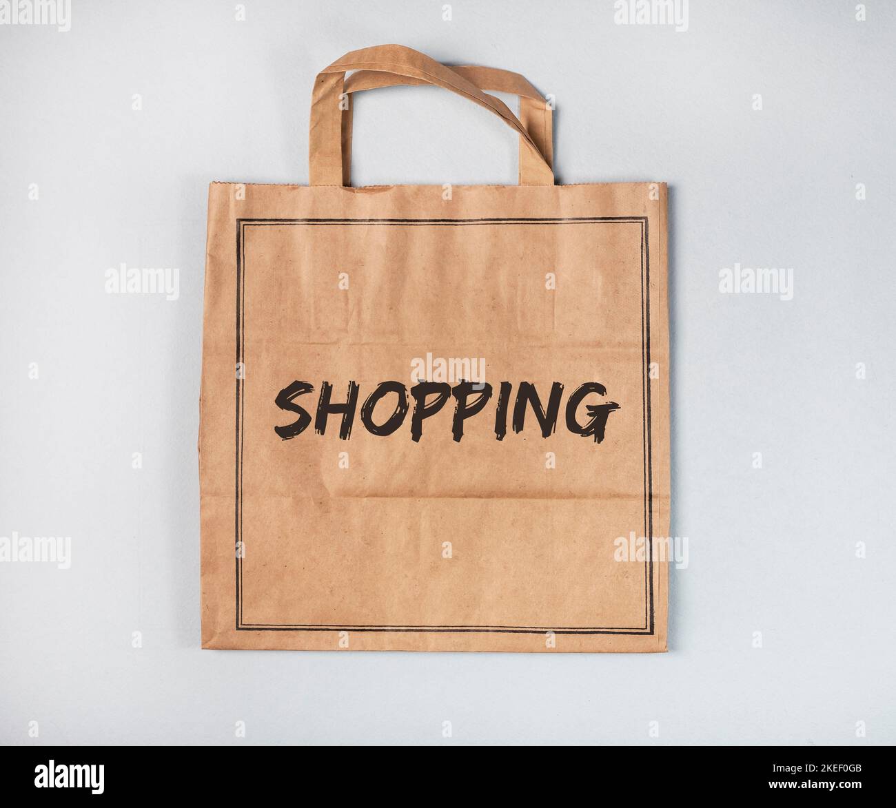 Shopping word on craft paper bag, empty package. Stock Photo