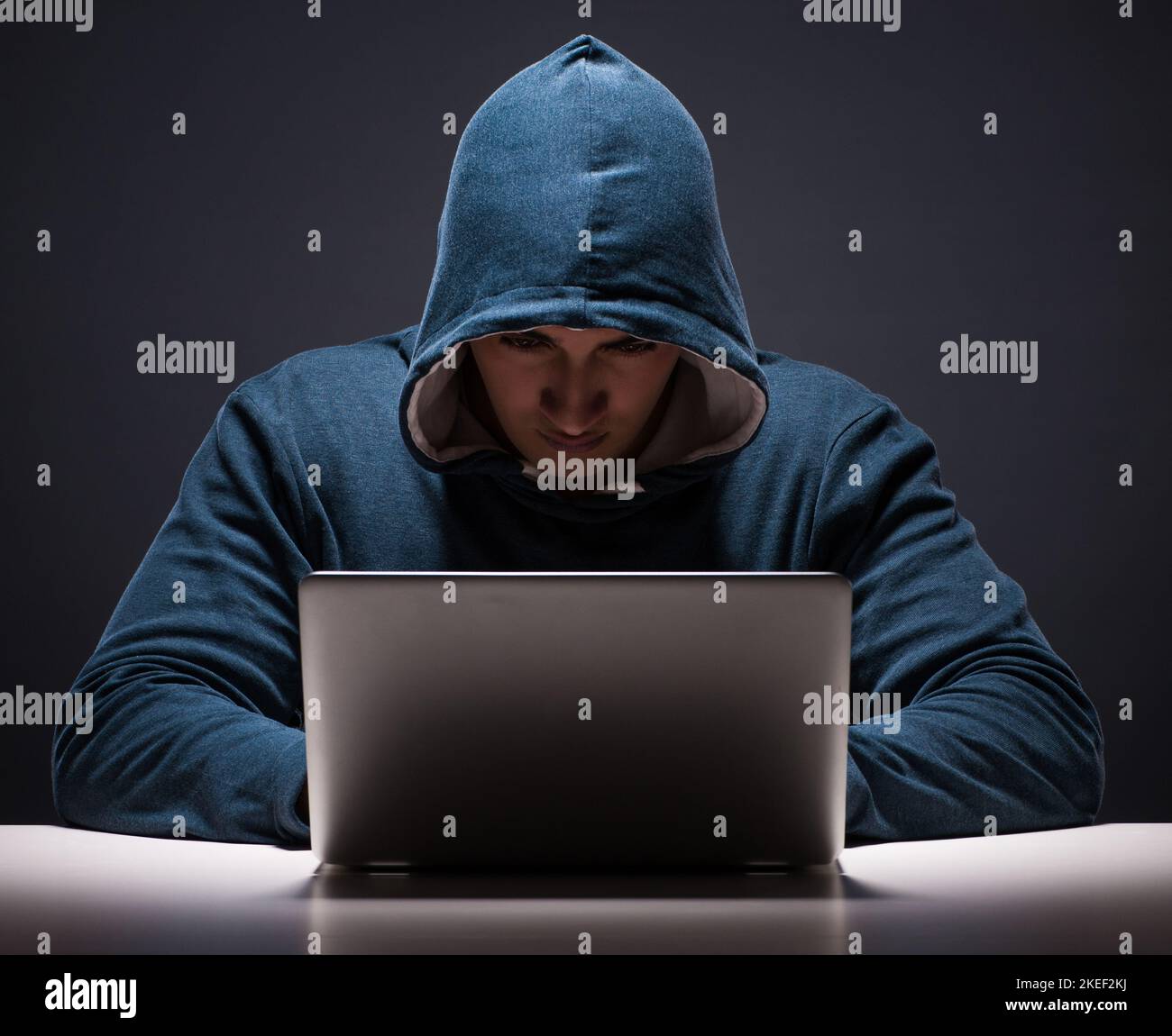 The computer hacker working in dark room Stock Photo - Alamy