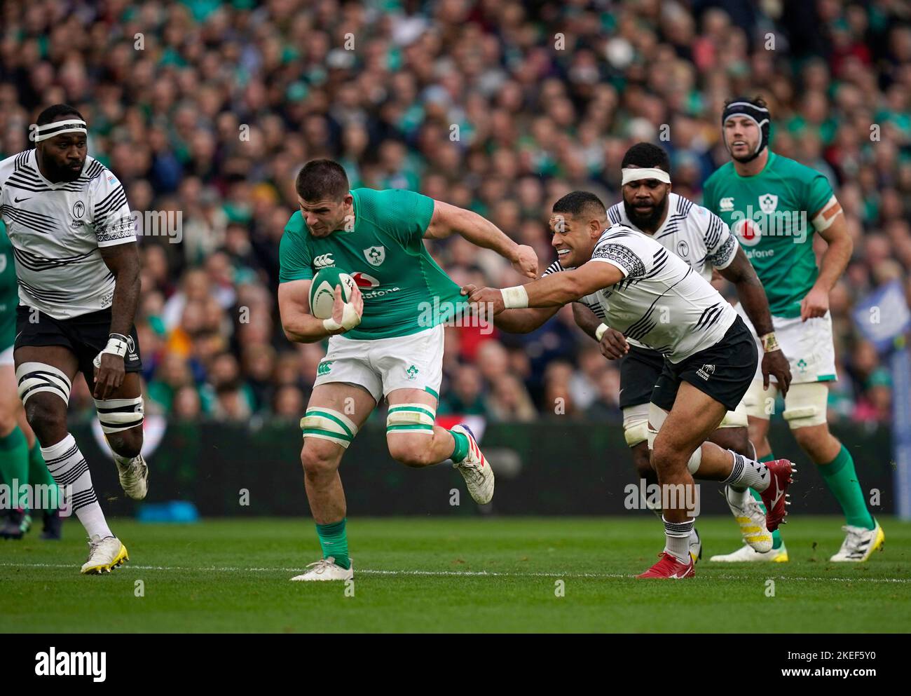 Ireland's Nick Timoney is pulled back by Fiji's Sam Matavesi (right) as he runs with the ball during the Autumn International match at the Aviva Stadium in Dublin, Ireland. Picture date: Saturday November 12, 2022. Stock Photo