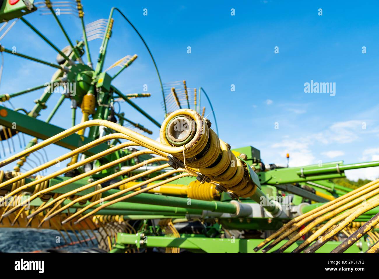 Close-up of a tedder against blue sky Stock Photo