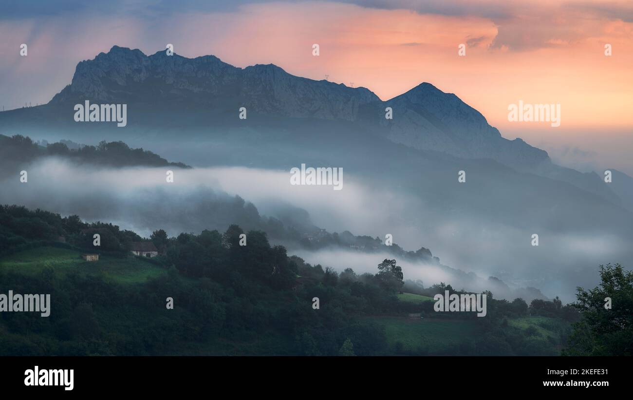 Misty and Foggy Morning View of Monsacro Mountain in Asturias Stock Photo