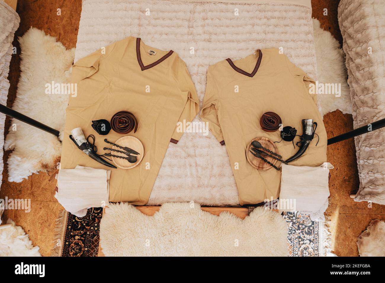 Hunten Robe A top view of a traditional robe and hunting weapons and equipment at a ...