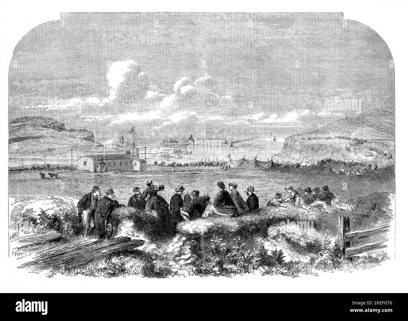 Local people watching the 'Caroline' laying the transatlantic telegraph cable at Foilhommerum in Valencia, County Kerry, Ireland during the 19th century Stock Photo
