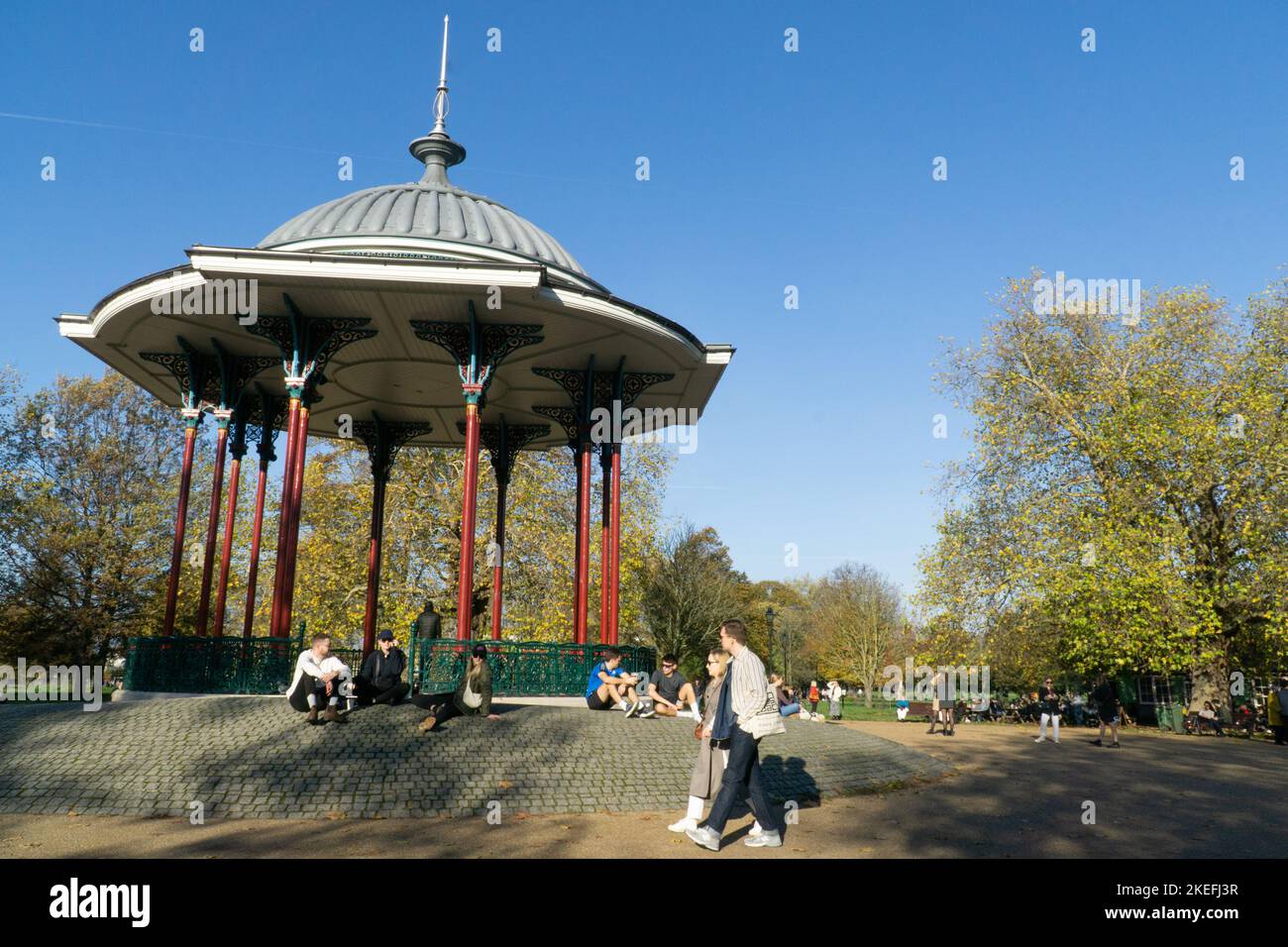 UK Weather, 12 November 2022: In Clapham, south London, the unusually mild weather and bright sunshine is a treat for people at outdoor cafes, for dog walkers, pram-pushers and cyclists on Clapham Common, and gives beautiful reflections in the ponds. Anna Watson/Alamy Live News Stock Photo