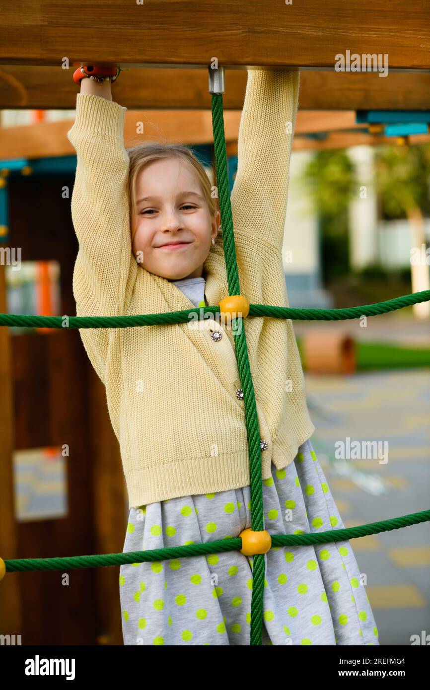 Little child girl portrait at playground, kid playing and hanging at ...