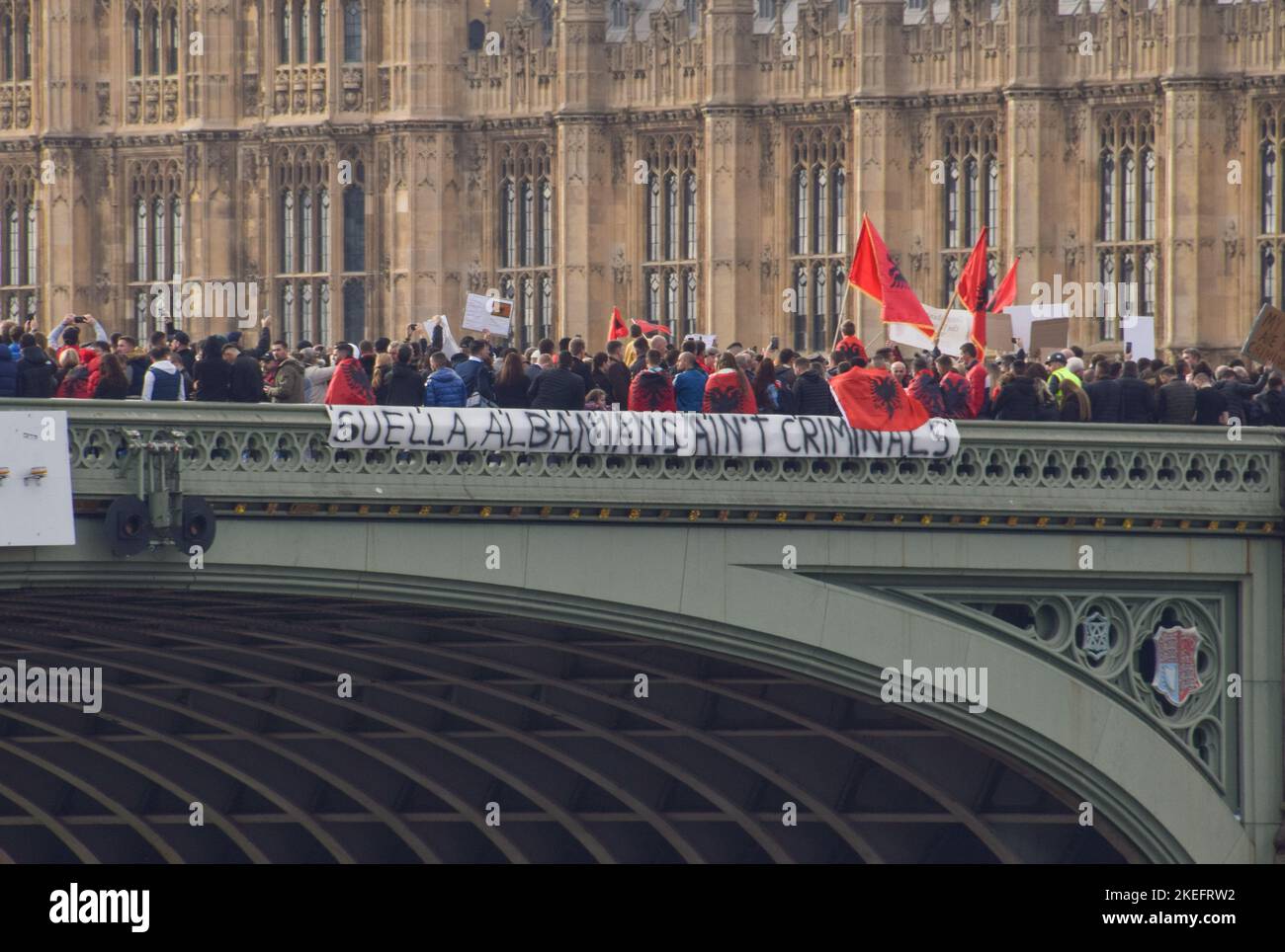 November 12, 2022, London, England, United Kingdom: Protesters drop a banner on Westminster Bridge. Albanians gathered in Westminster in protest against Home Secretary Suella Braverman after she stated that there was an 'invasion' of migrants in the UK and that criminal gangs from Albania are abusing the British immigration system. (Credit Image: © Vuk Valcic/ZUMA Press Wire) Stock Photo
