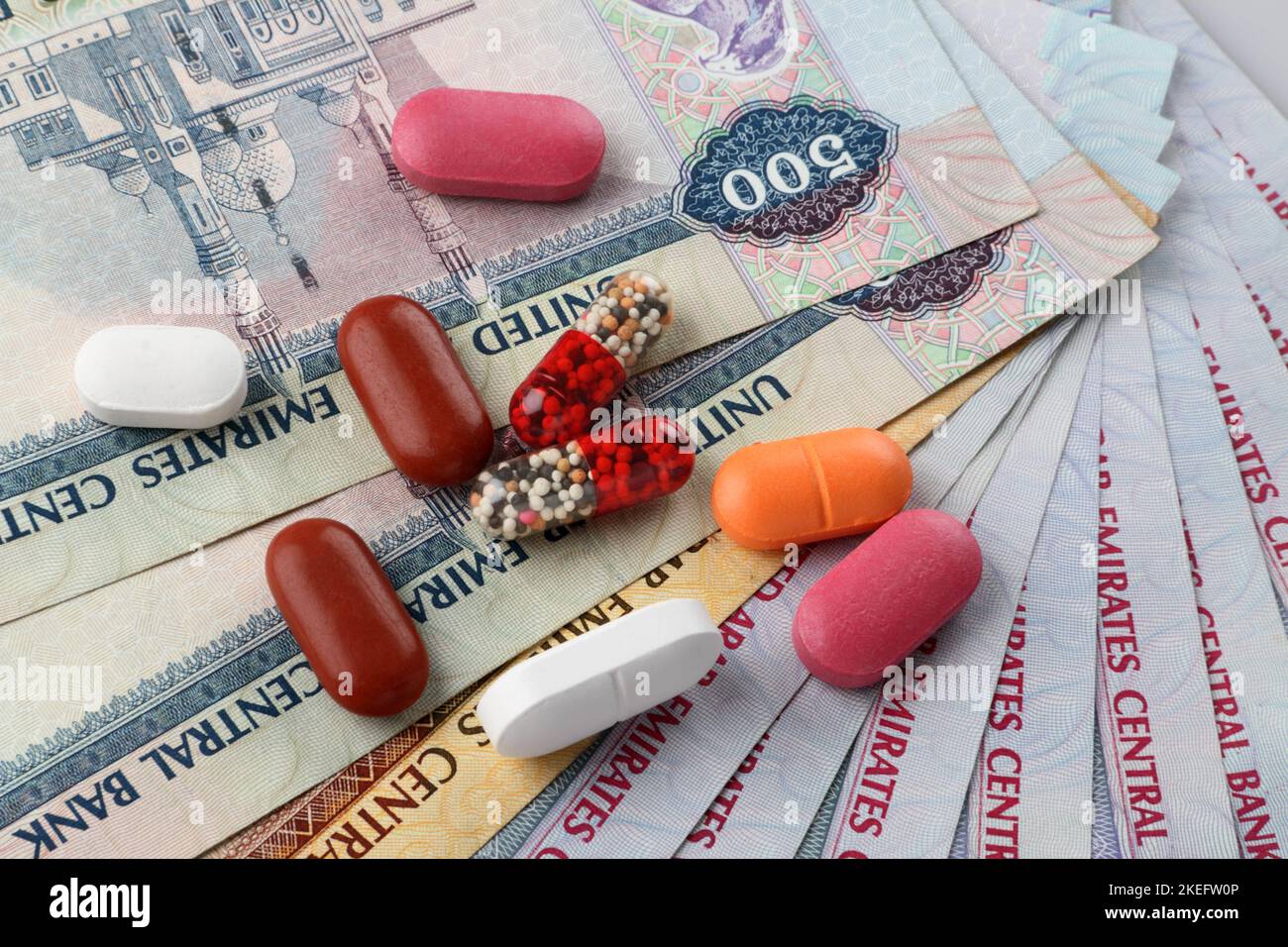 UAE Currency Dirhams and Medicine Pills Stock Photo
