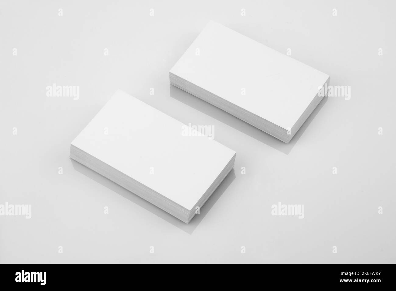 Blank Business Card Mockup on White Reflective Background Stock Photo