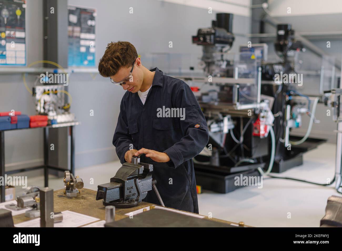 An Engineering student using tools in an engineering centre, college, university. Stock Photo