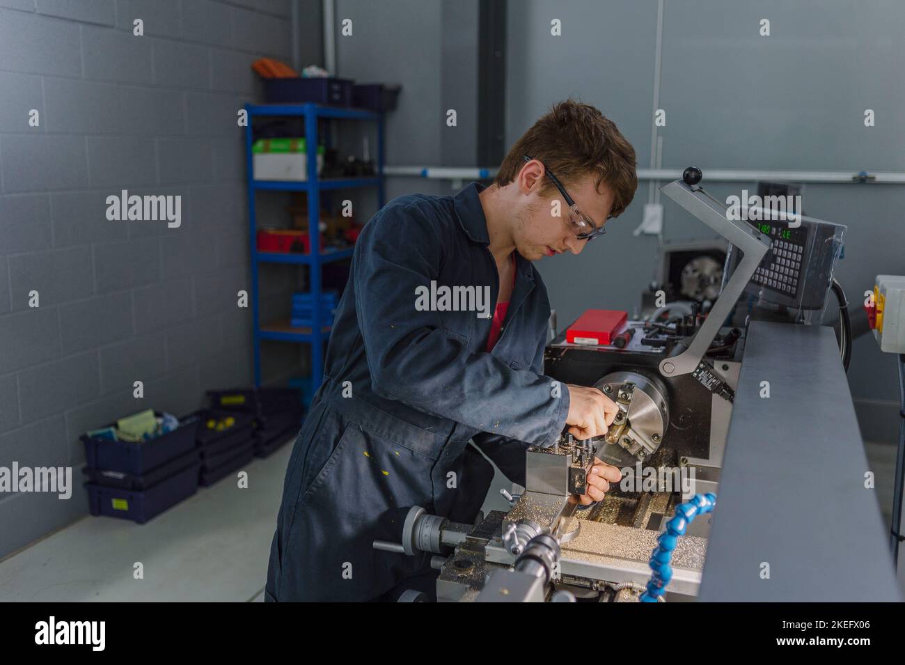 An Engineering student using tools in an engineering centre, college, university. Stock Photo