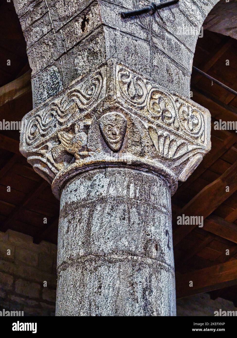 Romanesque capital characterized by typical High Middle Age figures and symbols. St. Paul's Church near Fivizzano town in Lunigiana, Tuscany, Italy. Stock Photo