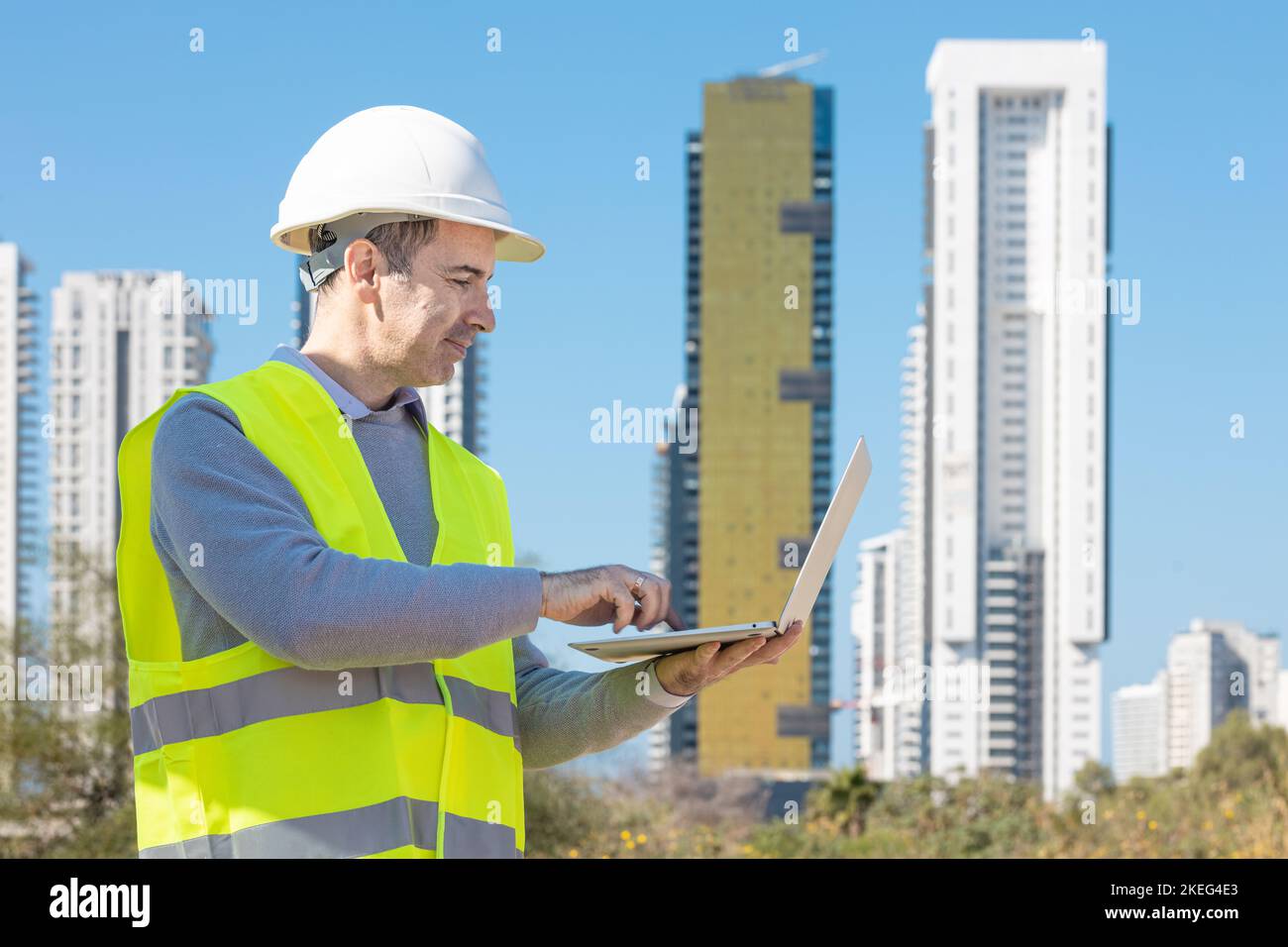 Professional builder standing with a notebook in front of the ...