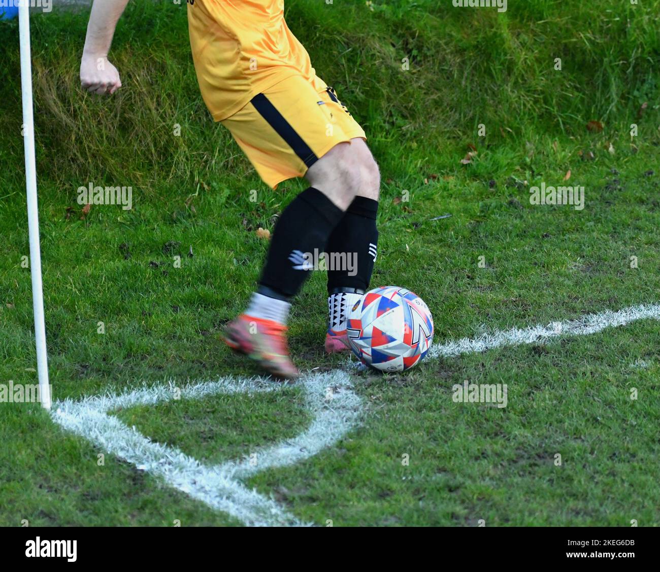 A footballer takes a corner kick from outside the quadrant Stock Photo