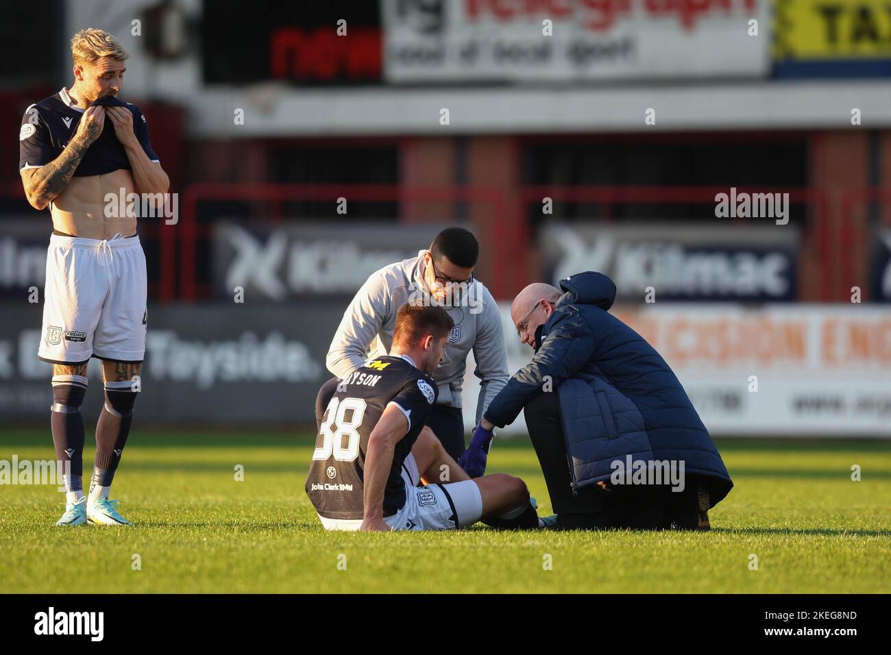 Dundee, Scotland, UK. 12th November 2022;  Dens Park, Dundee, Scotland: Scottish Championship football, Dundee versus Raith Rovers; Joe Grayson of Dundee receives treatment after he goes down injured Credit: Action Plus Sports Images/Alamy Live News Stock Photo