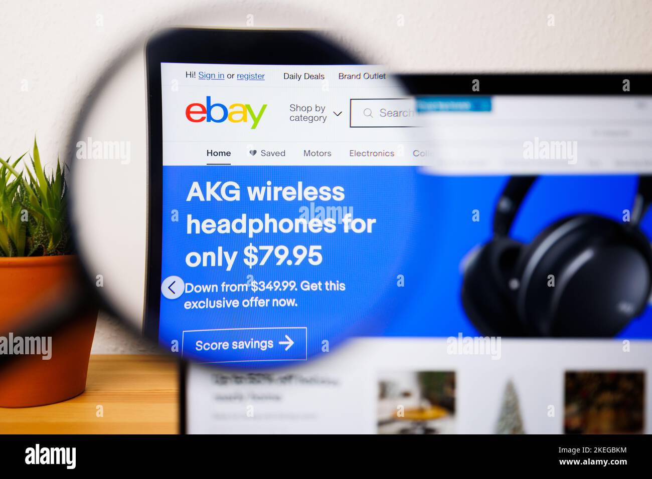 A logo of eBay on a laptop screen under a magnifying glass Stock Photo ...