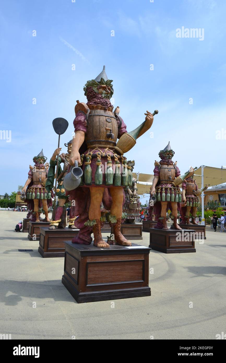 Milan, Italy - June 29 2015: Statue of Enolo winemaker standing in a group of statues of The Food People by Dante Ferretti at the Milan Expo 2015. Stock Photo
