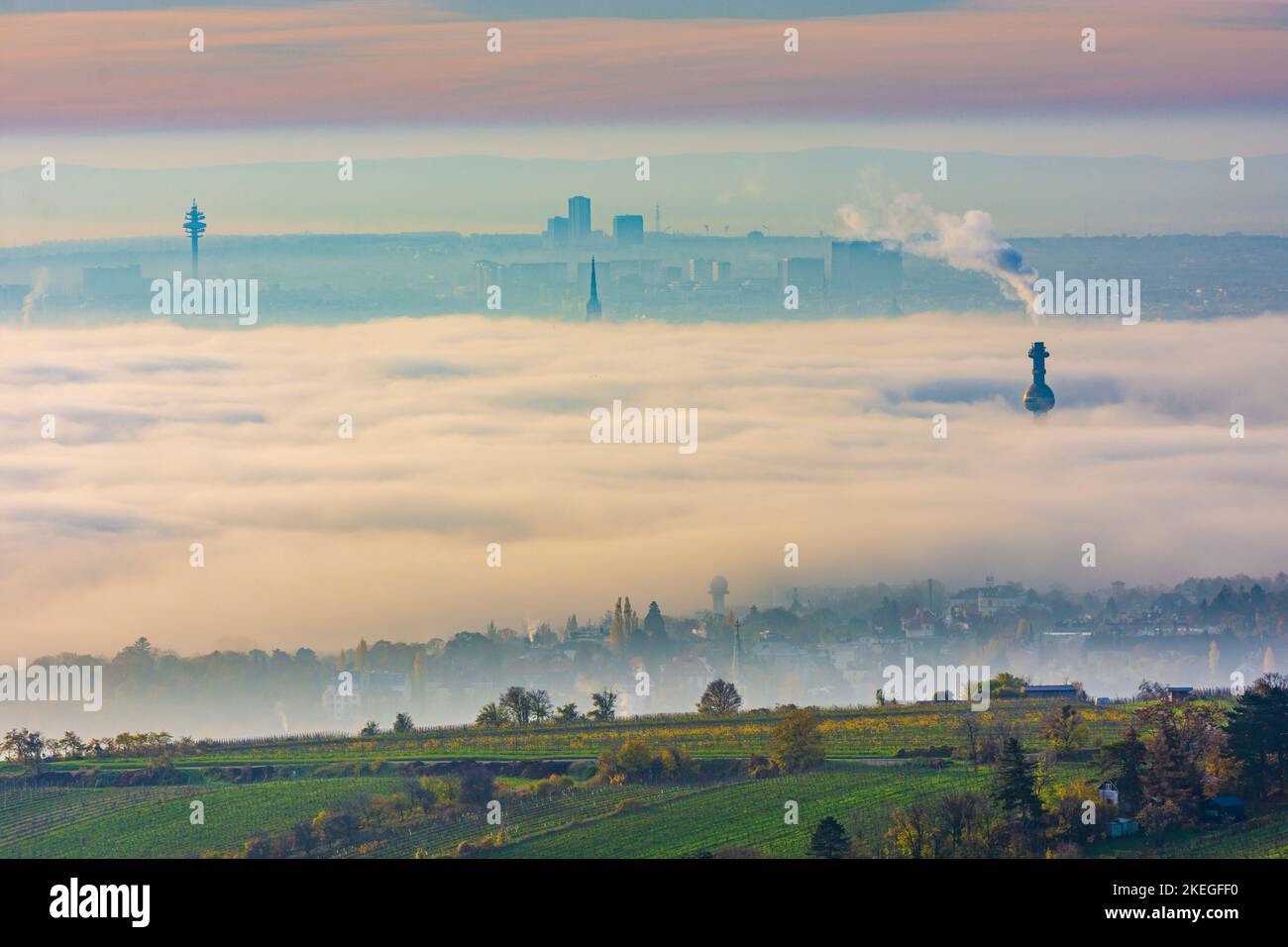 Wien, Vienna: towers stick out from ground fog, tower in Arsenal, steeple of Stephansdom (St. Stephen's Cathedral), chimney of Spittelau waste inciner Stock Photo
