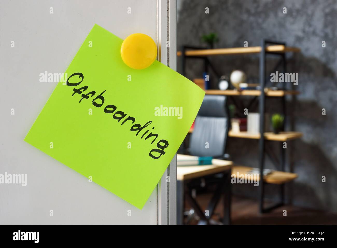 Sticker with word offboarding pinned on the whiteboard. Stock Photo
