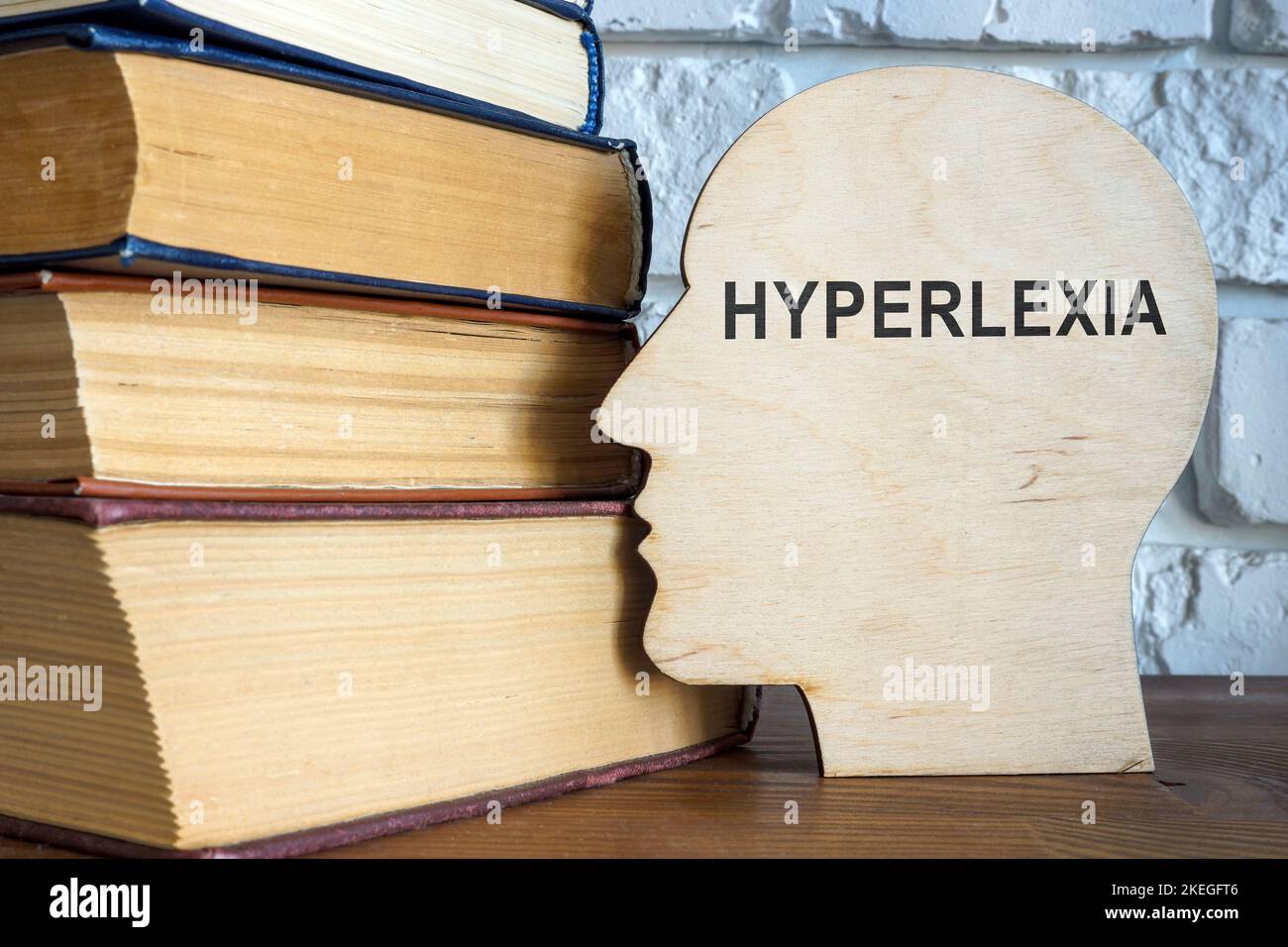 Wooden head with word hyperlexia and books Stock Photo Alamy