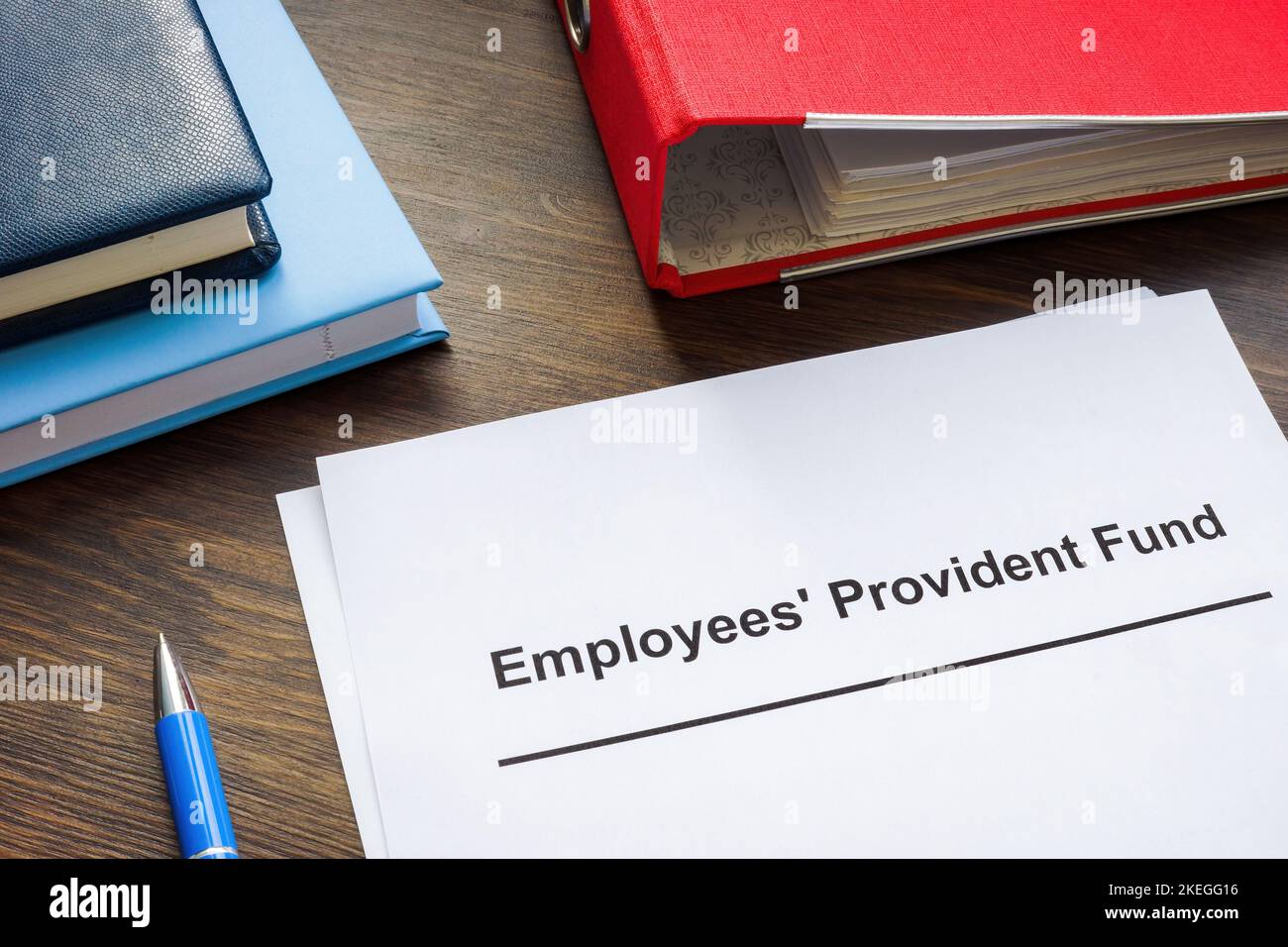 Documents about Employees Provident Fund and red folder. Stock Photo